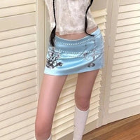 Pearlescent Blue Candle Graphic Mini Skirt — dettaglio della stampa